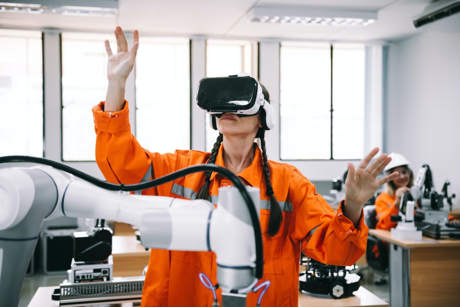 Engineering female wearing VR glasses for simulate control automation robotic welding machines