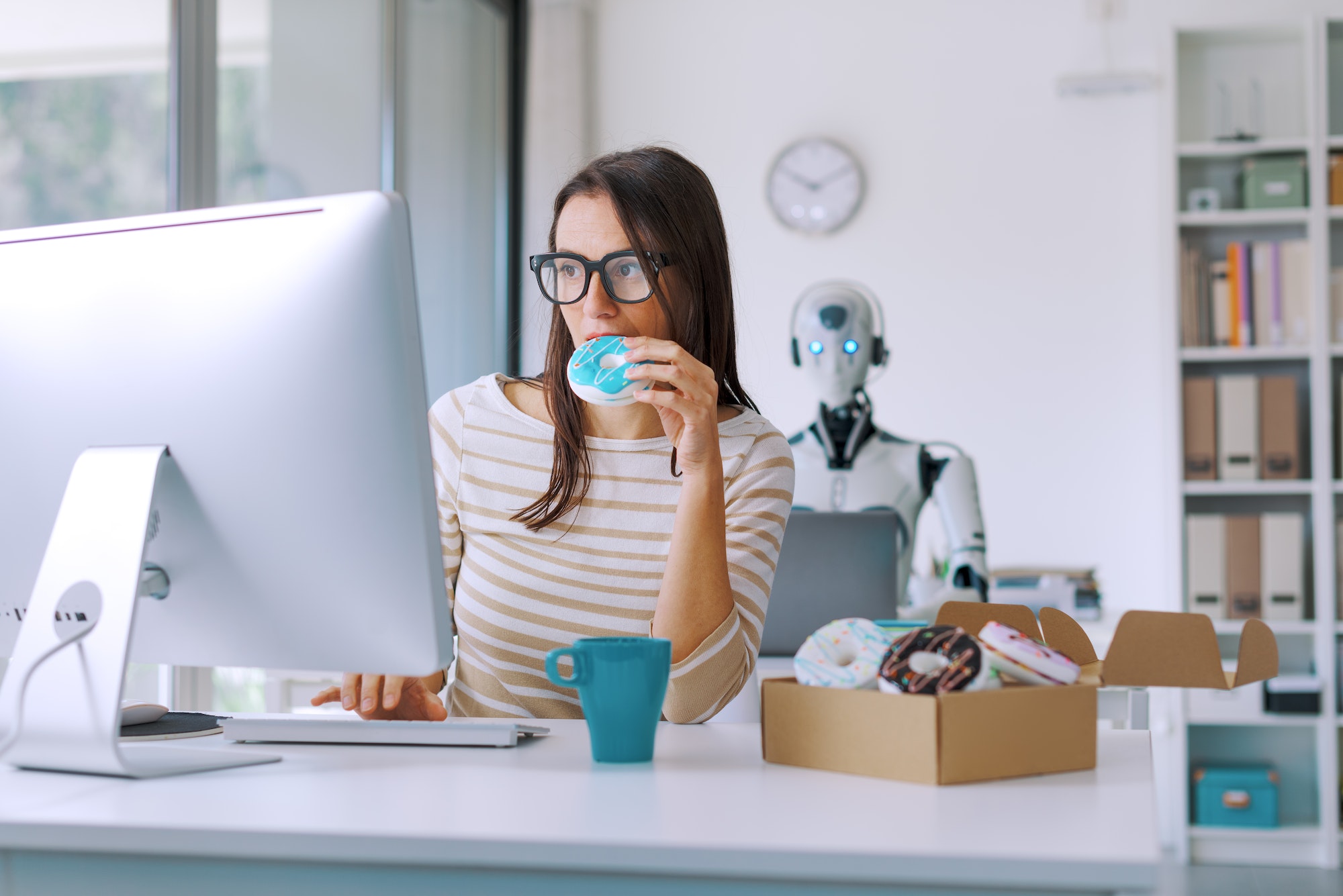 Woman and robot working in the office